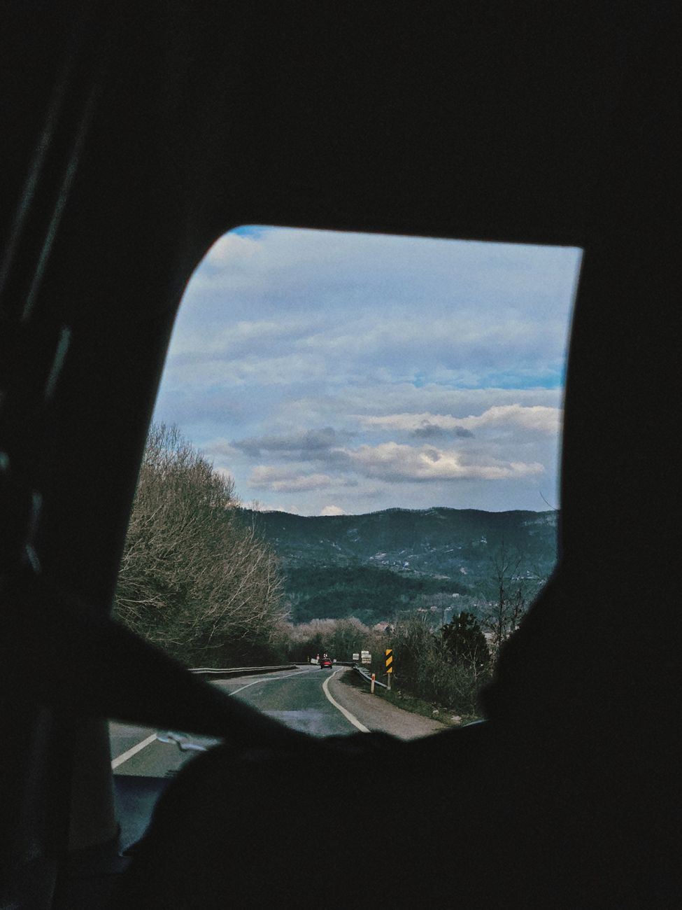 View of İstanbul's picturesque landscape through a car window during a calm road trip.