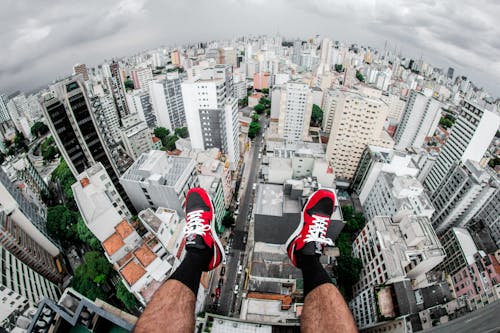 Man Sitting on Top of Buildng