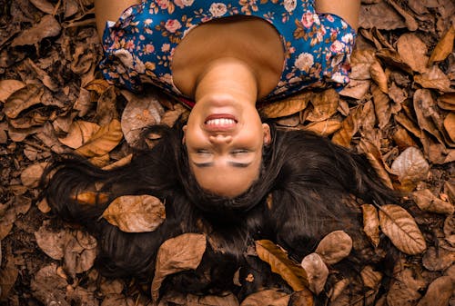 Free Woman Lying on Dried Leaves Stock Photo