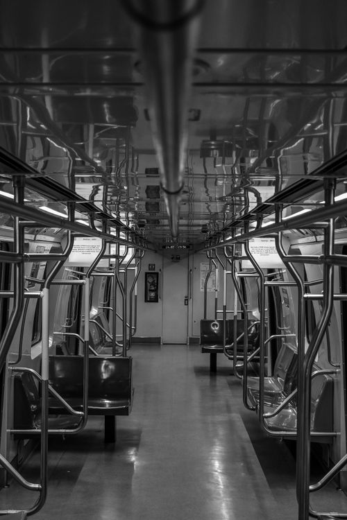 Free Monochrome inside view of a vacant subway train showcasing structure and lighting. Stock Photo