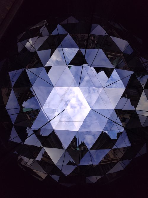 Free Abstract view of sky reflected in geometric mirrors, creating a kaleidoscope effect. Stock Photo