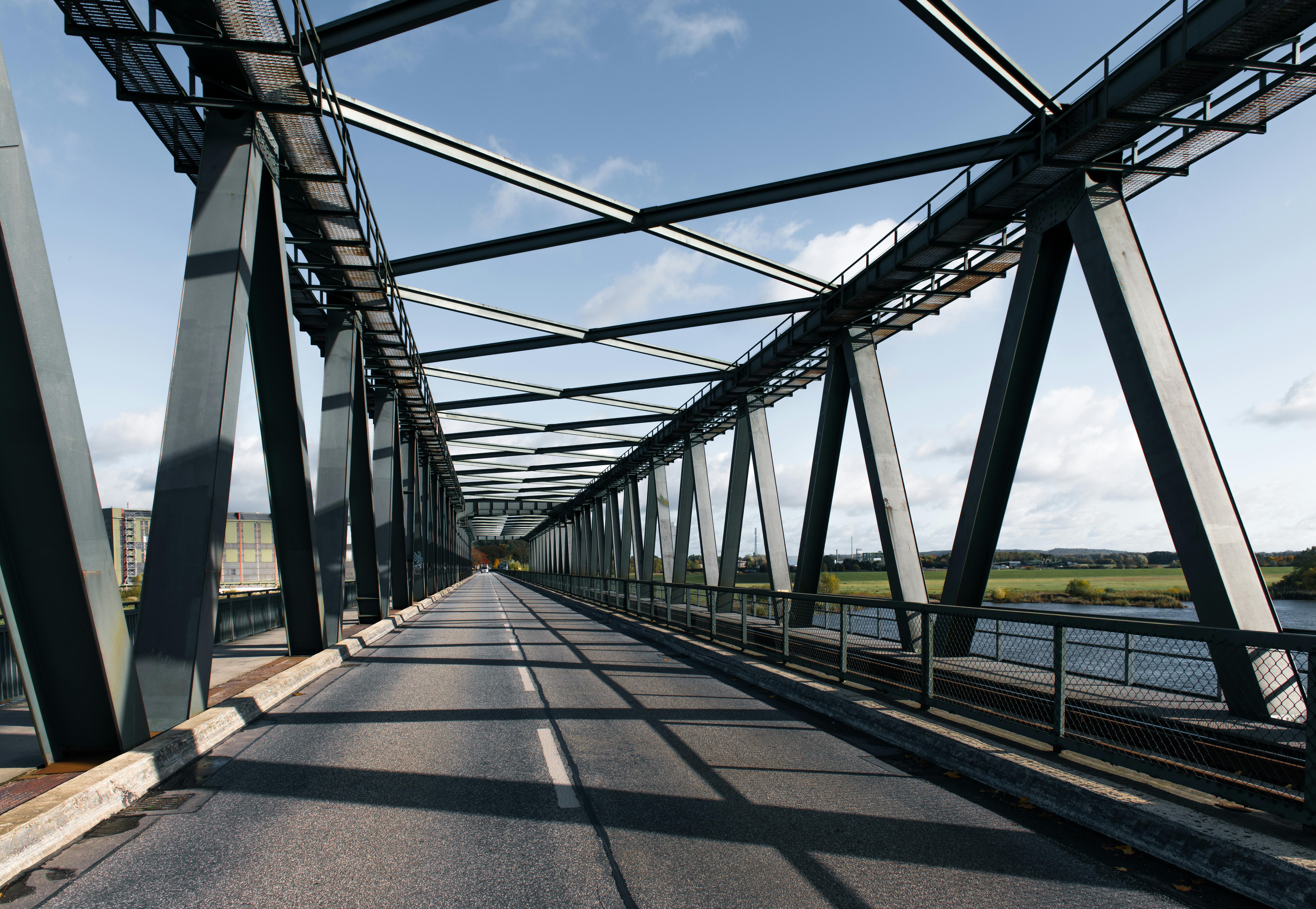 A steel bridge spanning a river in Lauenburg, Germany under a clear blue sky.