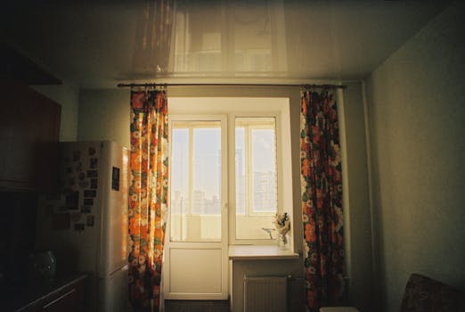 Cozy sunlit interior with floral curtains, window view, home decor