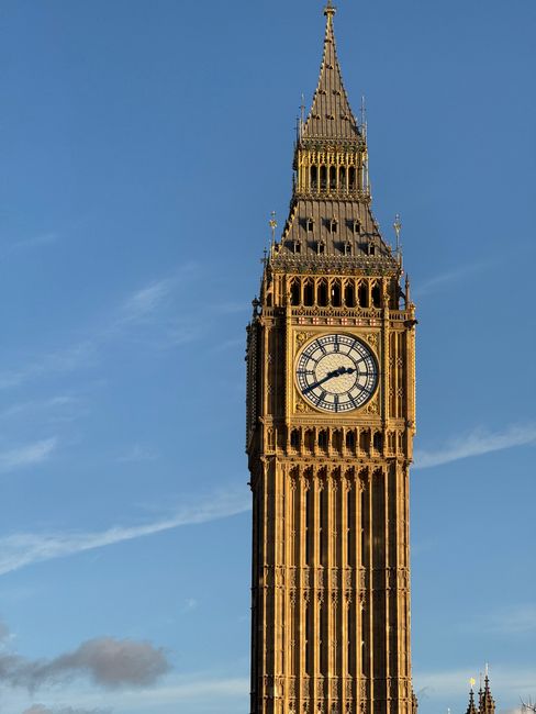 Close-up of the famous Big Ben clock tower in London under clear blue skies.