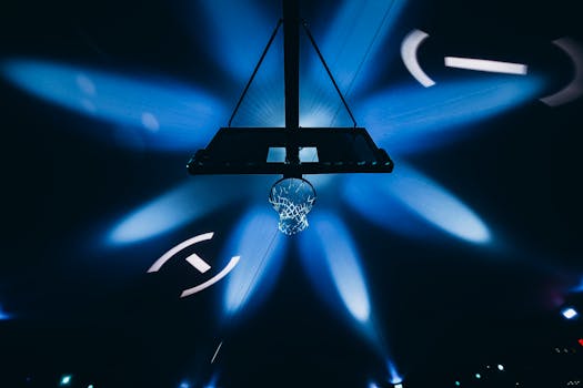 A striking image of a basketball hoop with vibrant light projections creating a dynamic atmosphere.