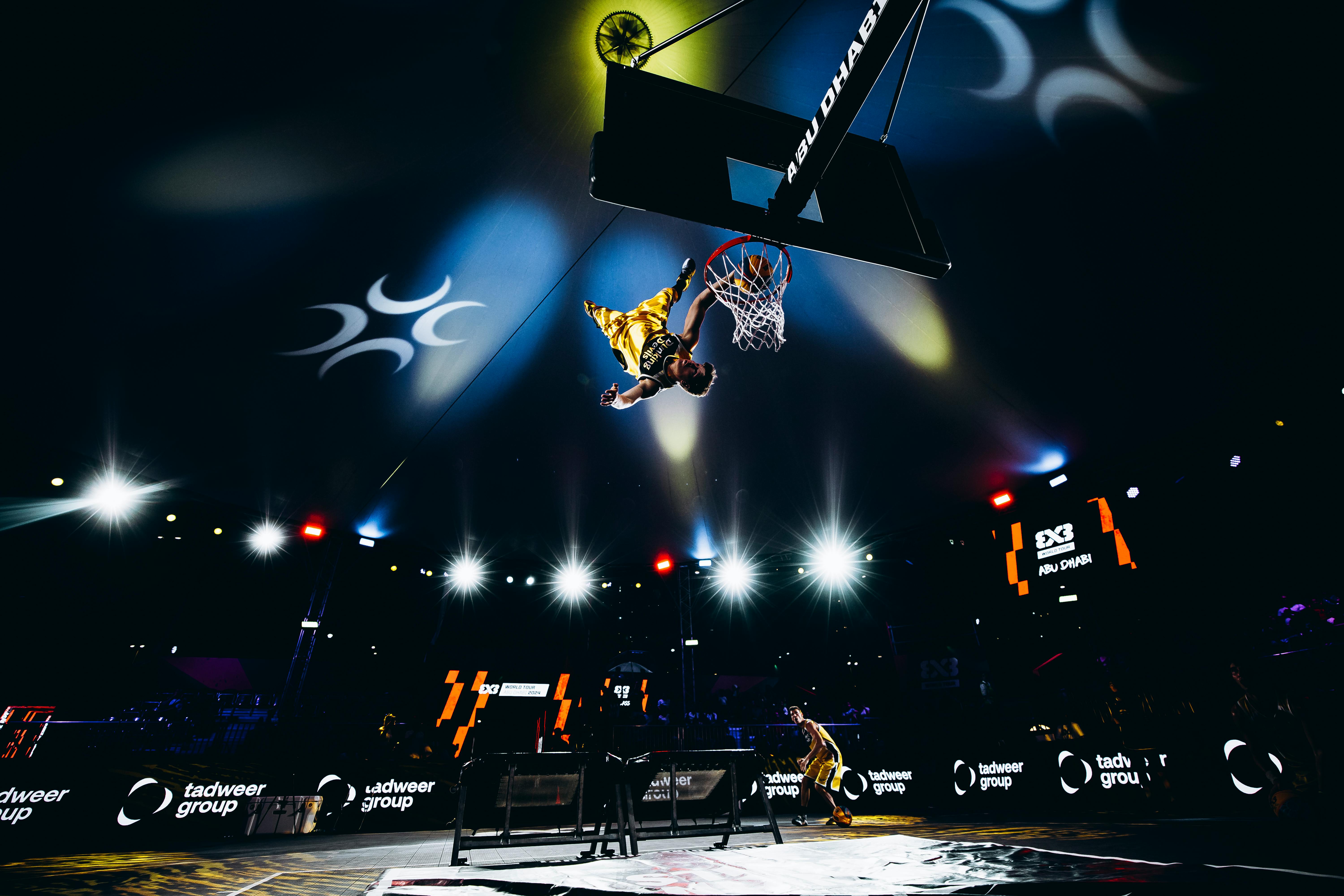High-energy slam dunk action at a basketball game in Abu Dhabi, UAE.