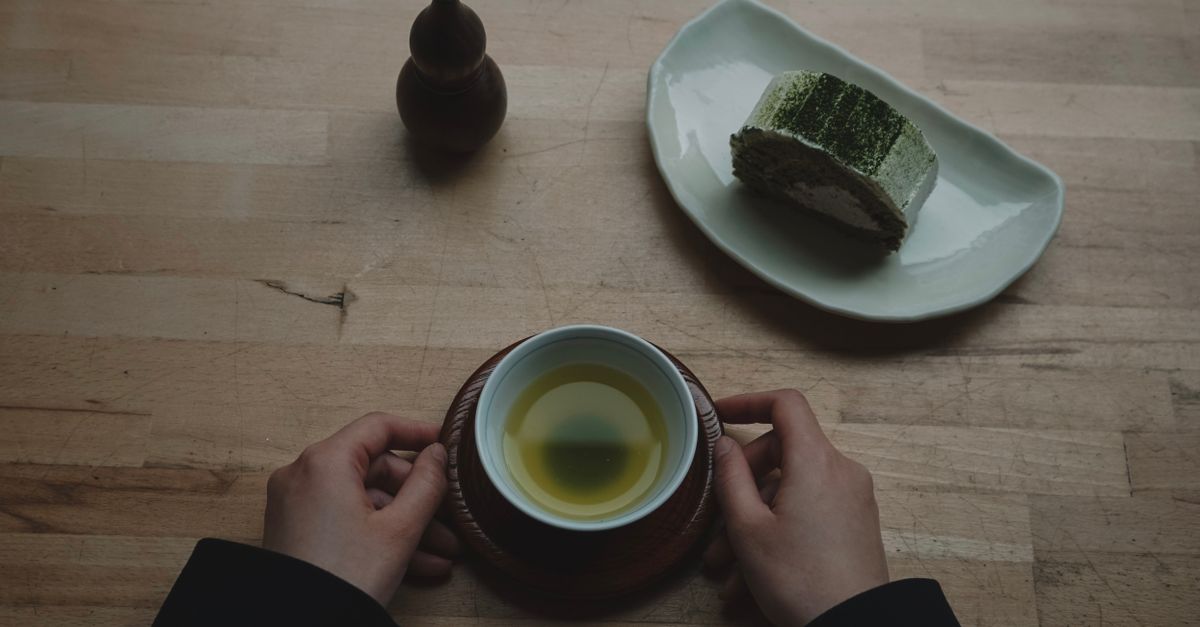 vintage Nokia 3310 on a minimalist wooden table next to a cup of matcha