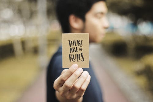 Person Holding Brown Card