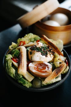 A vibrant Asian fusion salad with baby corn, soft-boiled egg, and fresh greens.