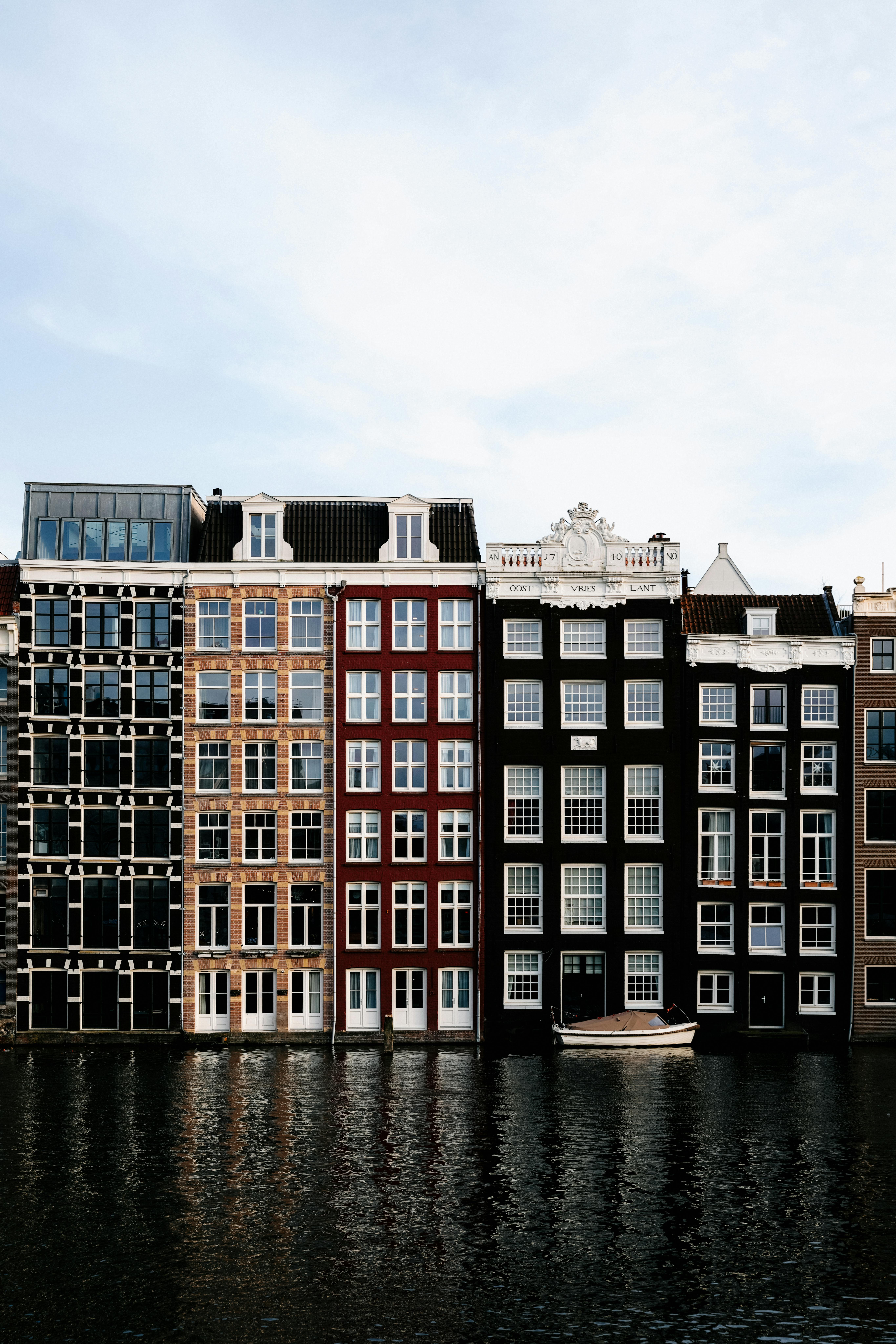 Charming Dutch architecture with vibrant facades along an Amsterdam canal.