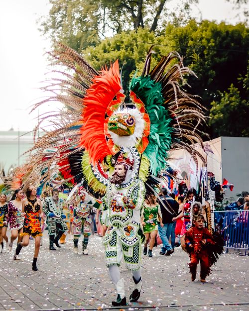 Free Colorful festival parade showcasing traditional feathered costumes and vibrant cultural dance. Stock Photo