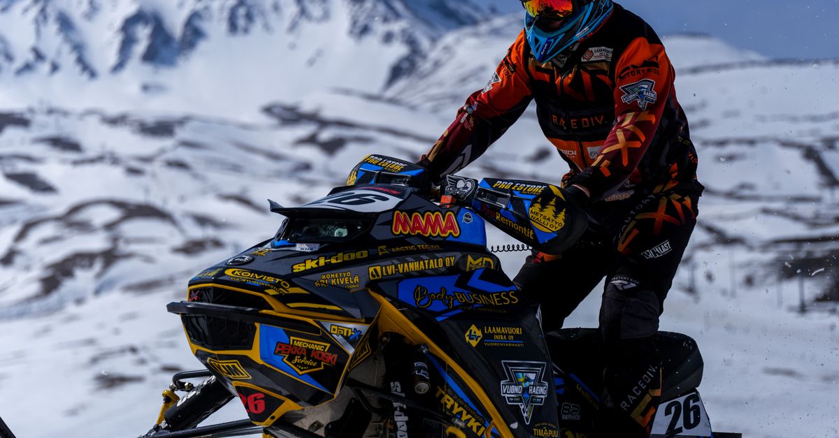 Jonathan Snowmobile Racing Thrilling Snowmobile Race in Snowy Mountains · Free Stock Photo