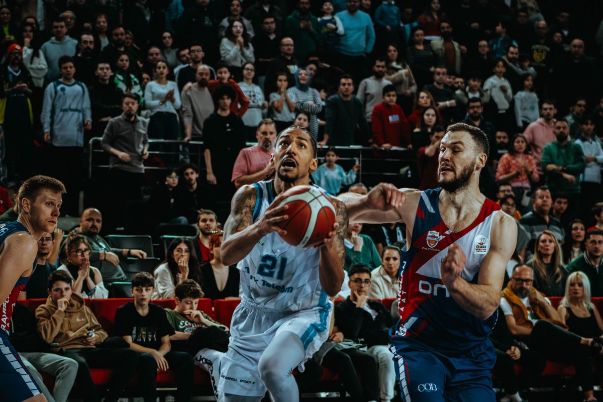 Game action during a basketball match with the crowd in the stands