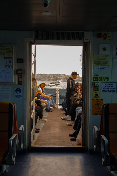Free Passengers enjoy a scenic ferry ride, capturing the essence of travel and leisure. Stock Photo