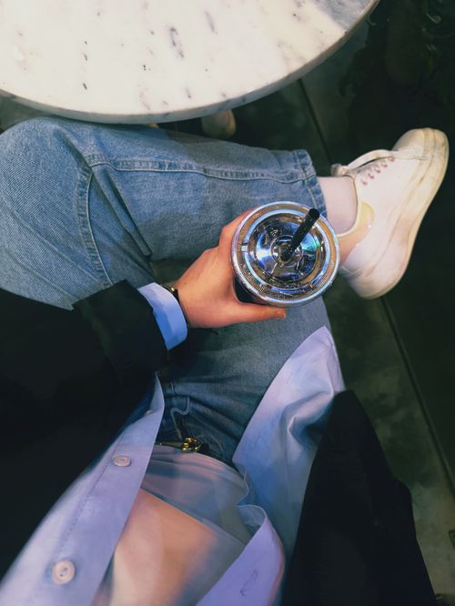 Free Chilled coffee moment captured at a cafe with stylish attire. Stock Photo
