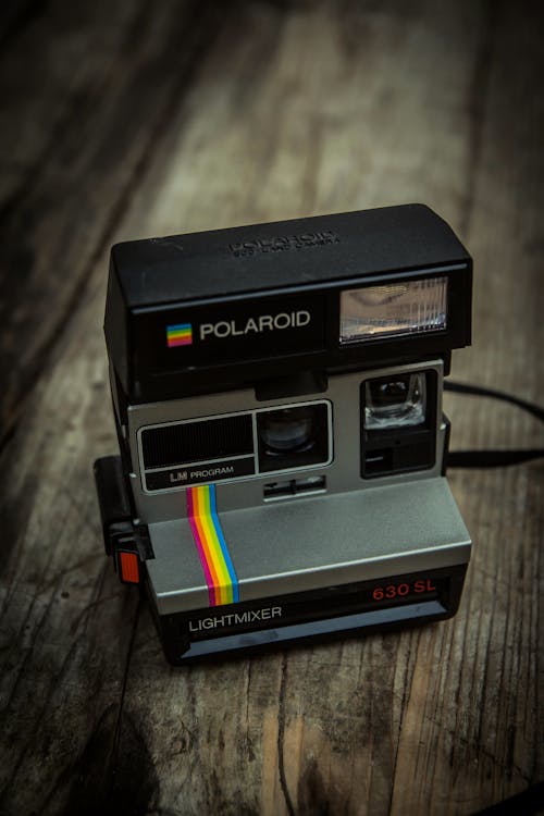 Photo Of Polaroid On Wooden Surface