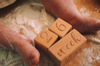 Cute Baby Feet with Wooden Milestone Blocks