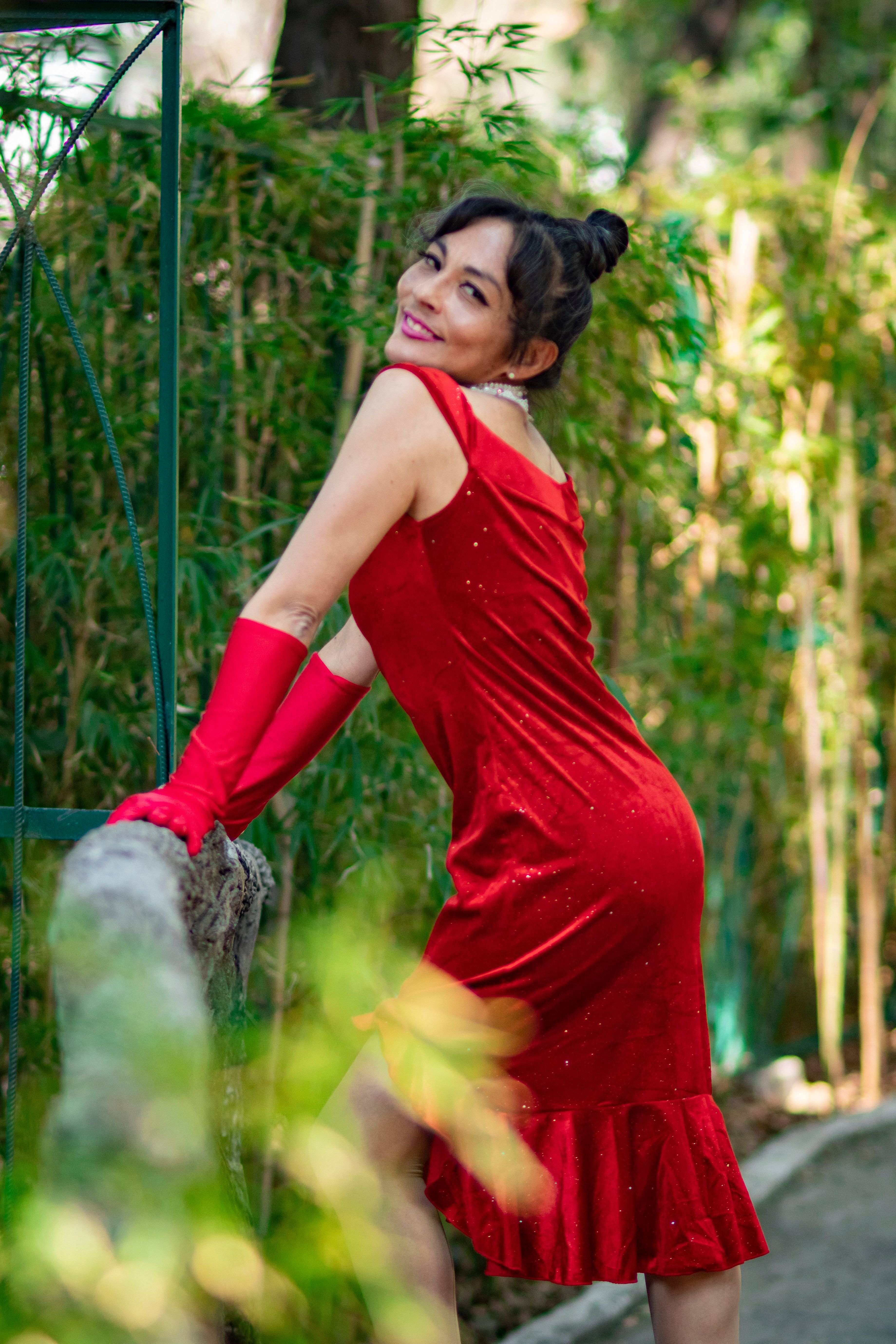 Elegant Woman in Red Dress Among Bamboo Outdoors · Free Stock Photo