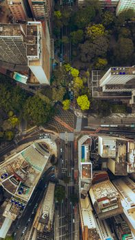 Dynamic aerial shot of city streets and skyscrapers, showcasing urban life and architecture.
