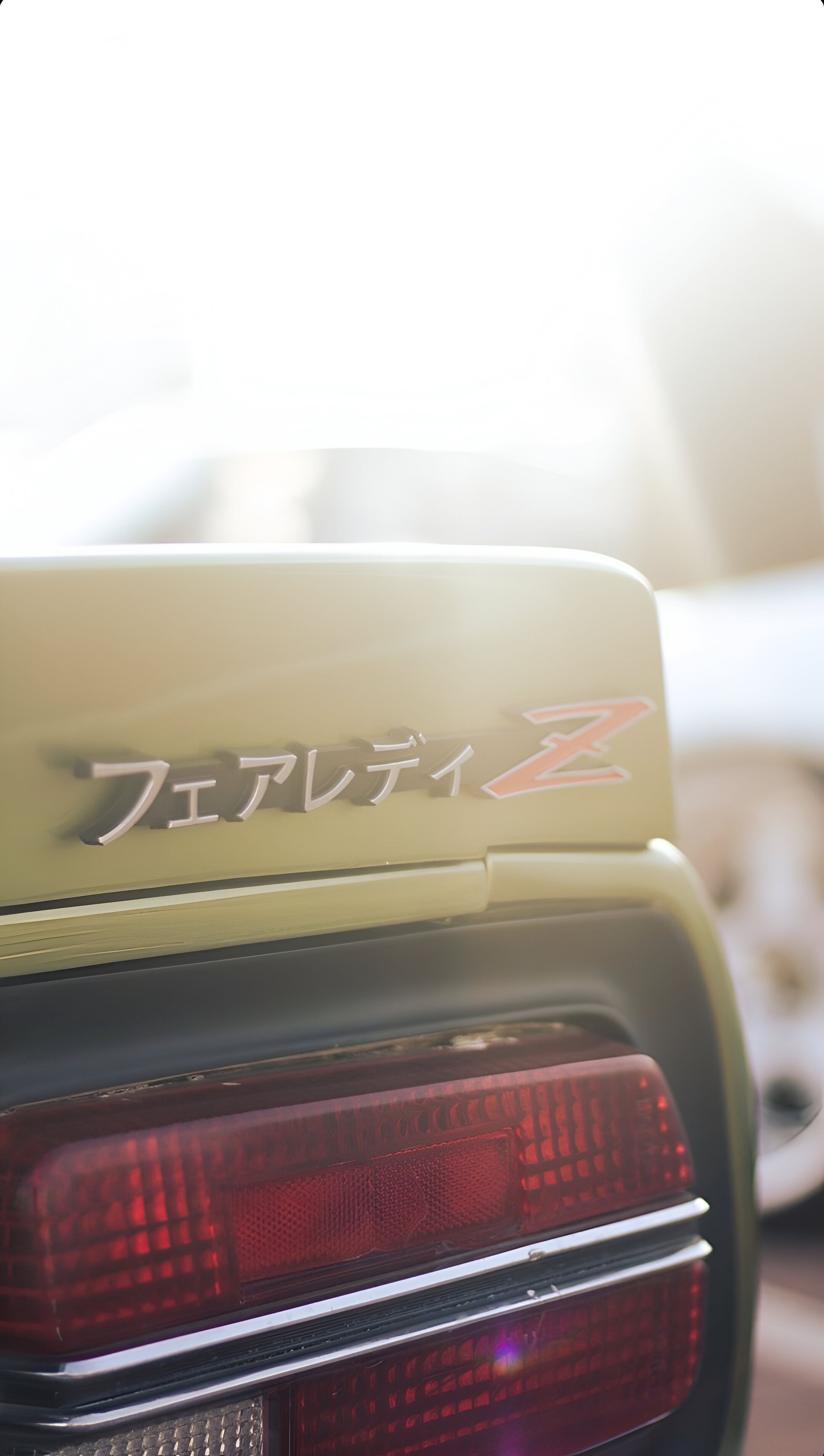 Close-up of a Nissan Fairlady Z tail light shot during a sunny day at a car meet in Dubai.