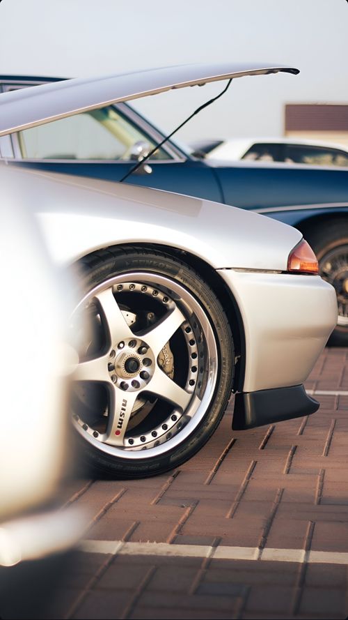 Free A classic Nissan Skyline showcased at a car meet in Dubai, featuring iconic chrome rims. Stock Photo