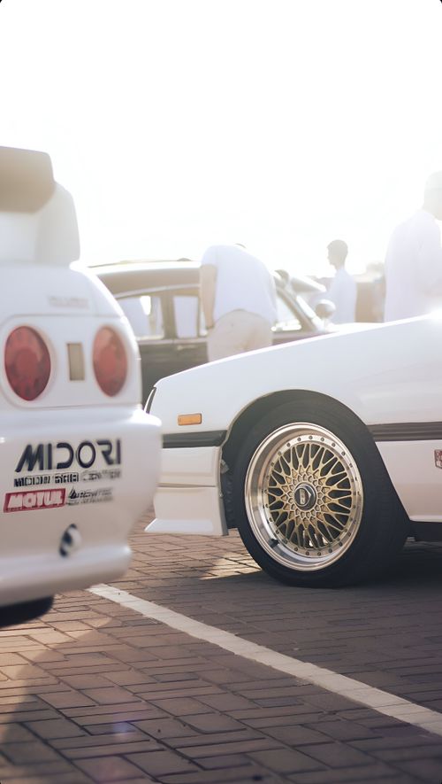 Free A 90s Nissan Skyline at a car meet in Dubai with chrome rims capturing the vintage car culture. Stock Photo