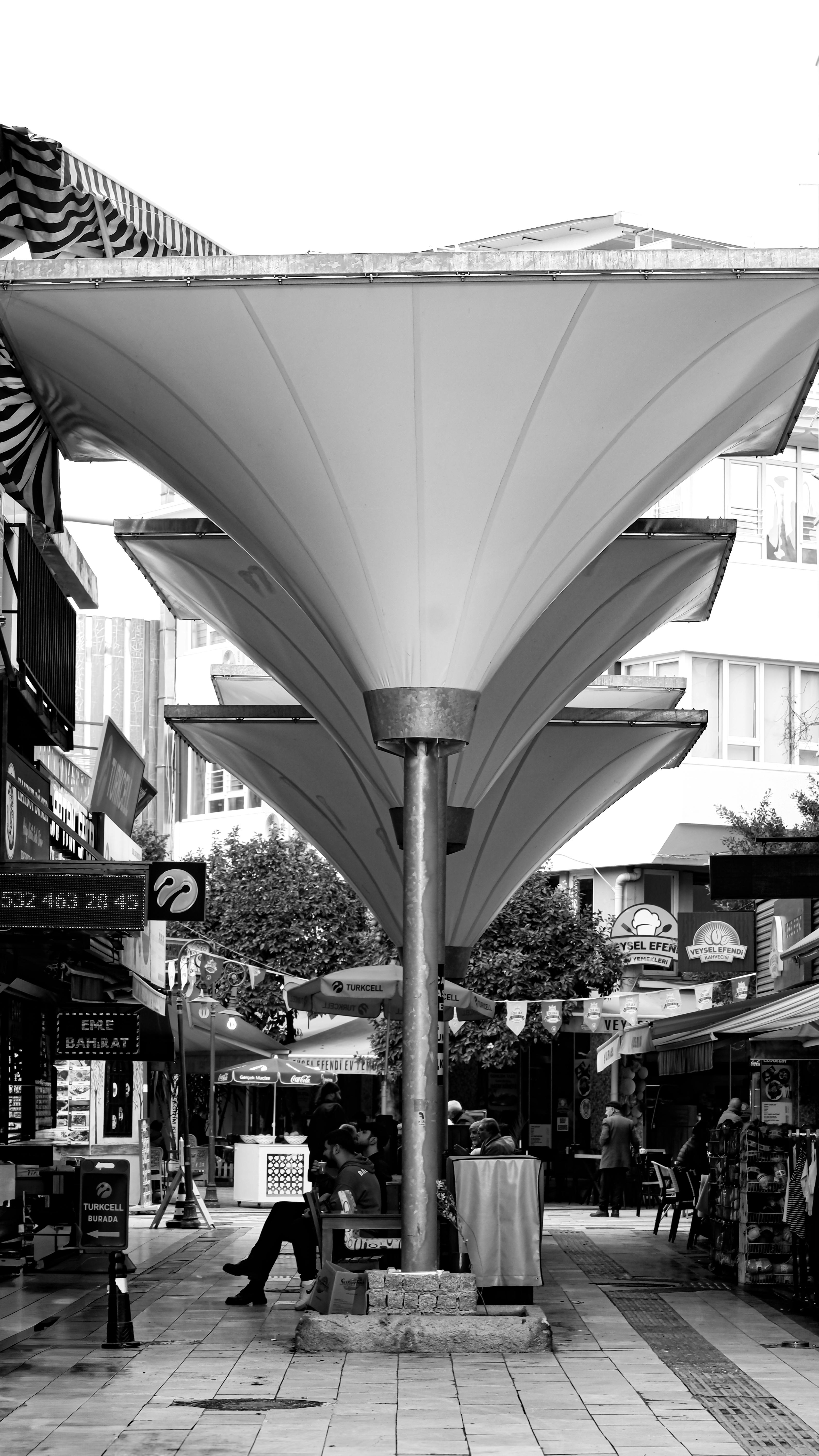Explore a unique urban canopy structure in a bustling city market.