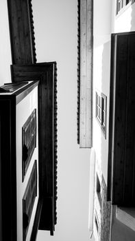 A dramatic view of building facades showing contrasting lines and angles in black and white.