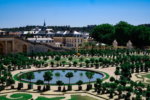 Free A stunning view of the landscaped gardens at the Palace of Versailles, showcasing symmetry and design. Stock Photo