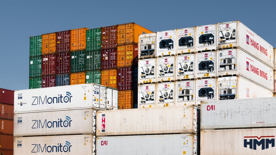 Colorful stacked shipping containers at Hamburg port, Germany, showcasing global trade logistics.