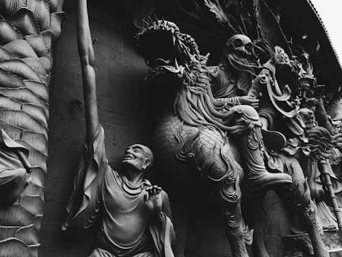 Grayscale Photo of Statues