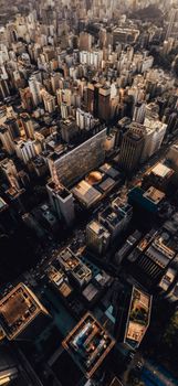 Discover a vibrant cityscape with dense skyscrapers from an aerial perspective, showcasing the beauty of urban architecture at twilight.