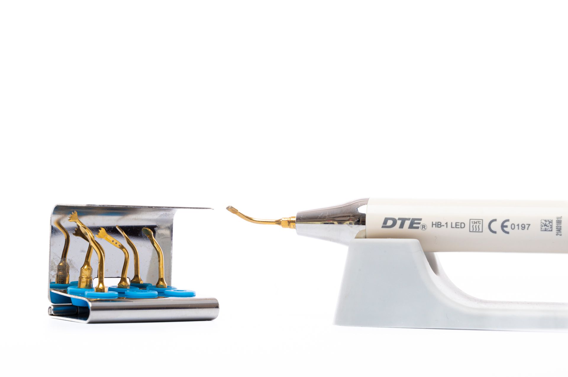 Close up of a dental ultrasonic scaler tool with multiple insert tips for dental hygiene.
