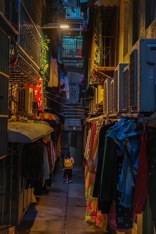 Free A vibrant narrow alleyway in Macau, filled with hanging laundry and colorful lights. Stock Photo