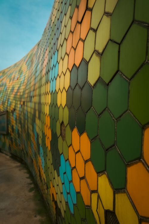 Free Vibrant mosaic wall featuring hexagonal tiles in various colors, forming an abstract pattern. Stock Photo