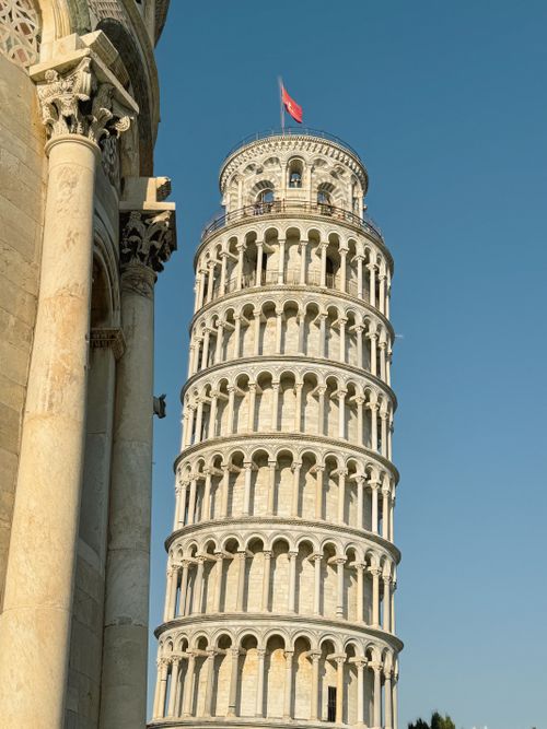 Free The iconic Leaning Tower of Pisa in Tuscany, Italy, against a bright sky. Stock Photo