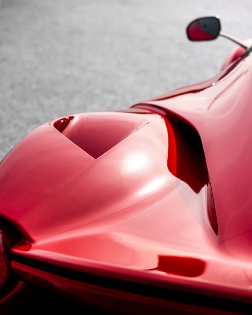 Free Close-up view of a stylish red sports car's rear with aerodynamic curves. Stock Photo