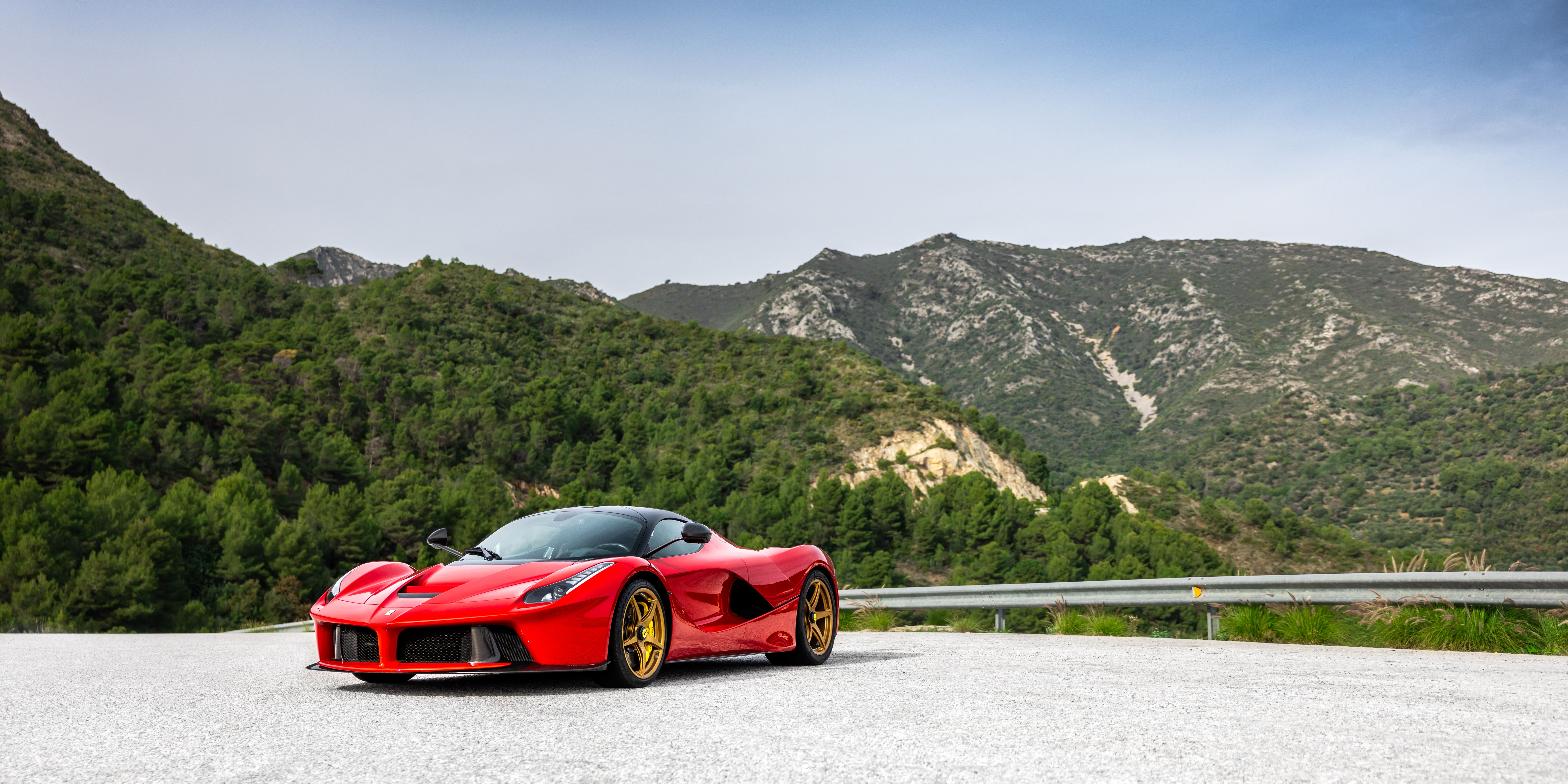 Red Supercar on a Scenic Forest Road · Free Stock Photo