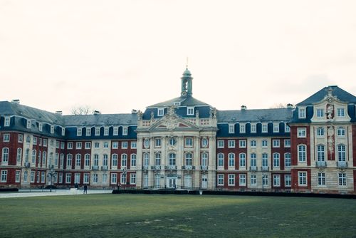 Free A grand view of the Baroque style Schloss Münster, showcasing its intricate architecture. Stock Photo