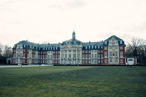 Free Elegant Baroque-style castle with symmetrical design and historical charm. Stock Photo