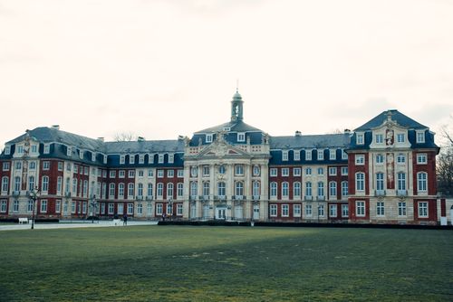 Free A magnificent view of the Baroque architecture of Münster Palace on a cloudy day. Stock Photo