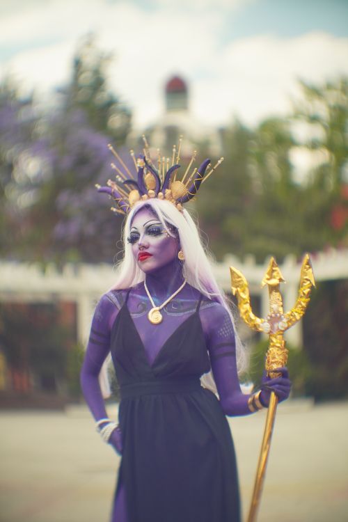 Free Stunning cosplay of a sea witch character holding a gold trident. Stock Photo