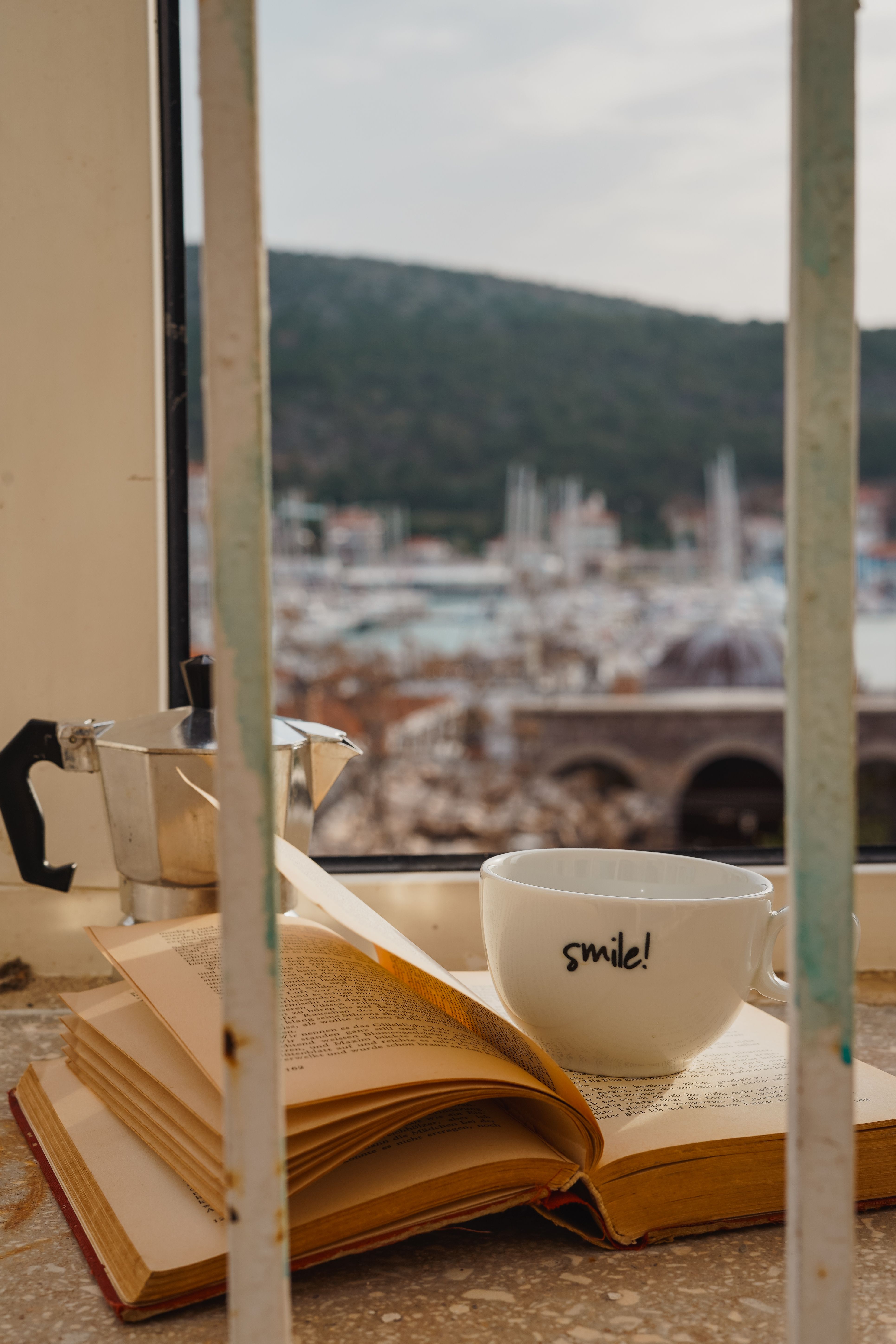 Picture of Cozy Reading Nook with Coffee and City View · Free Stock Photo