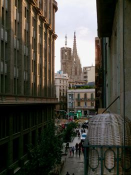 Charming street view in Barcelona with a glimpse of the Gothic Cathedral in the background.