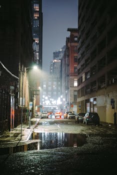 A moody and atmospheric street scene in Seattle, Washington, captured at twilight with reflections on wet pavement.