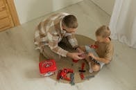 Father and Son Building Toy Tools in Living Room