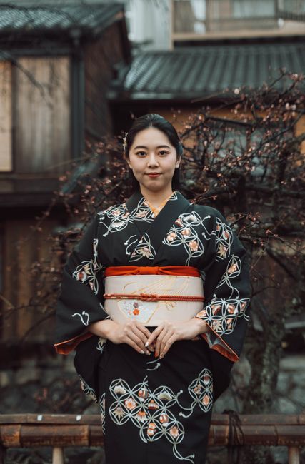 Japanese woman in a kimono posing outside in Kyoto, Japan.