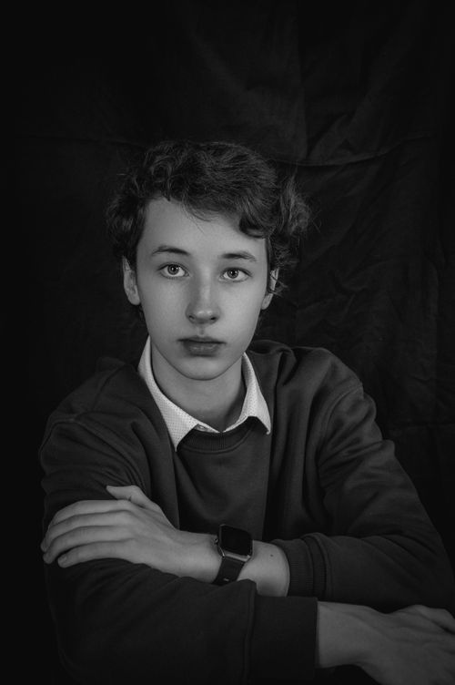Free A pensive teenager in a black and white portrait wearing a smartwatch. Stock Photo