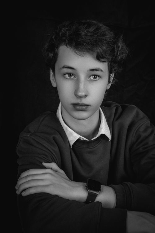 Free Captivating black and white portrait of a teenage boy wearing a smartwatch. Stock Photo