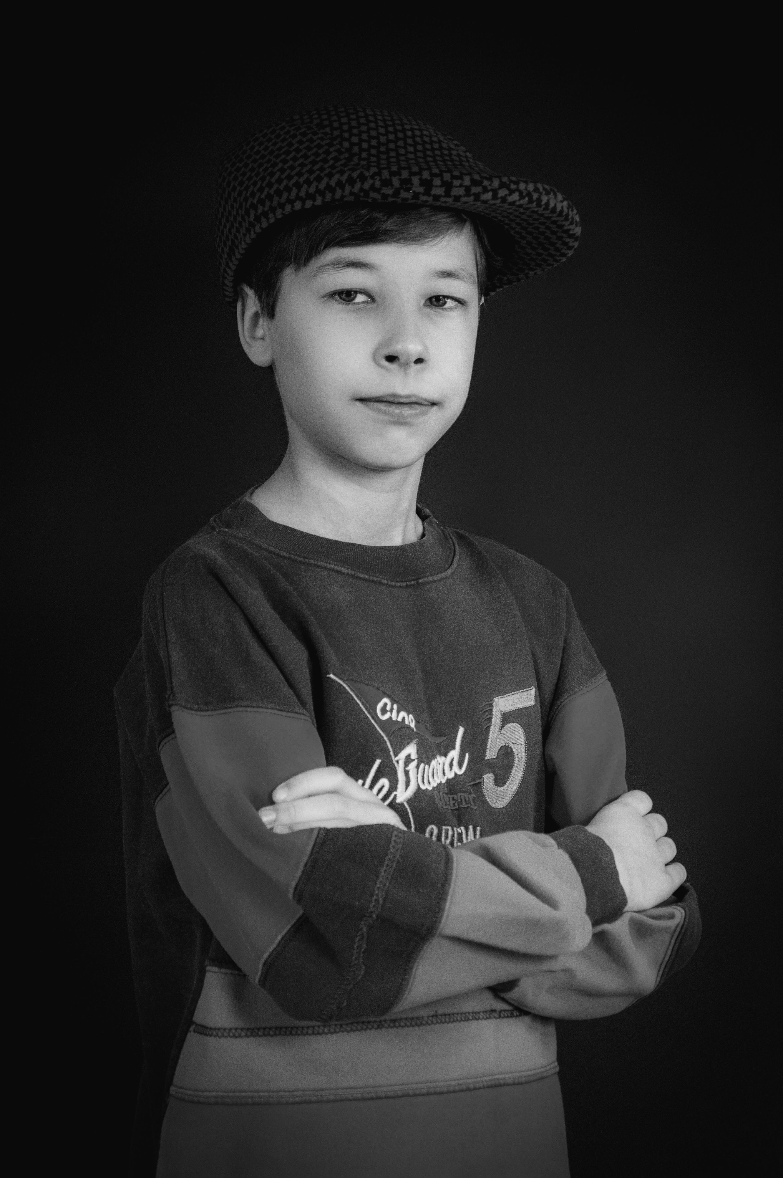 Retrato atemporal em preto e branco de um jovem confiante usando um chapéu.